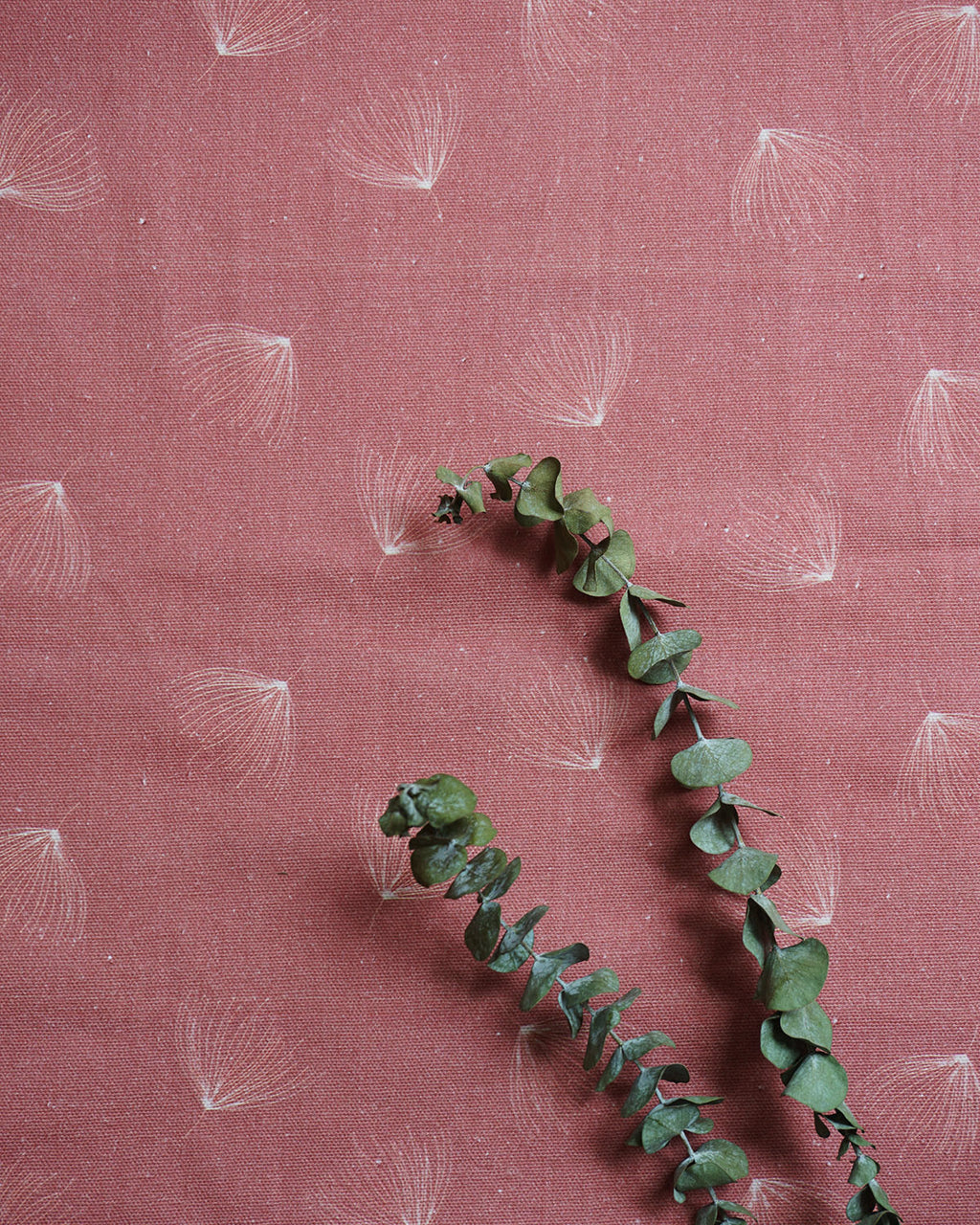 Brishti print fabric in dry-rose with fine linear, rain-inspired strokes; minimal, modern look. 
