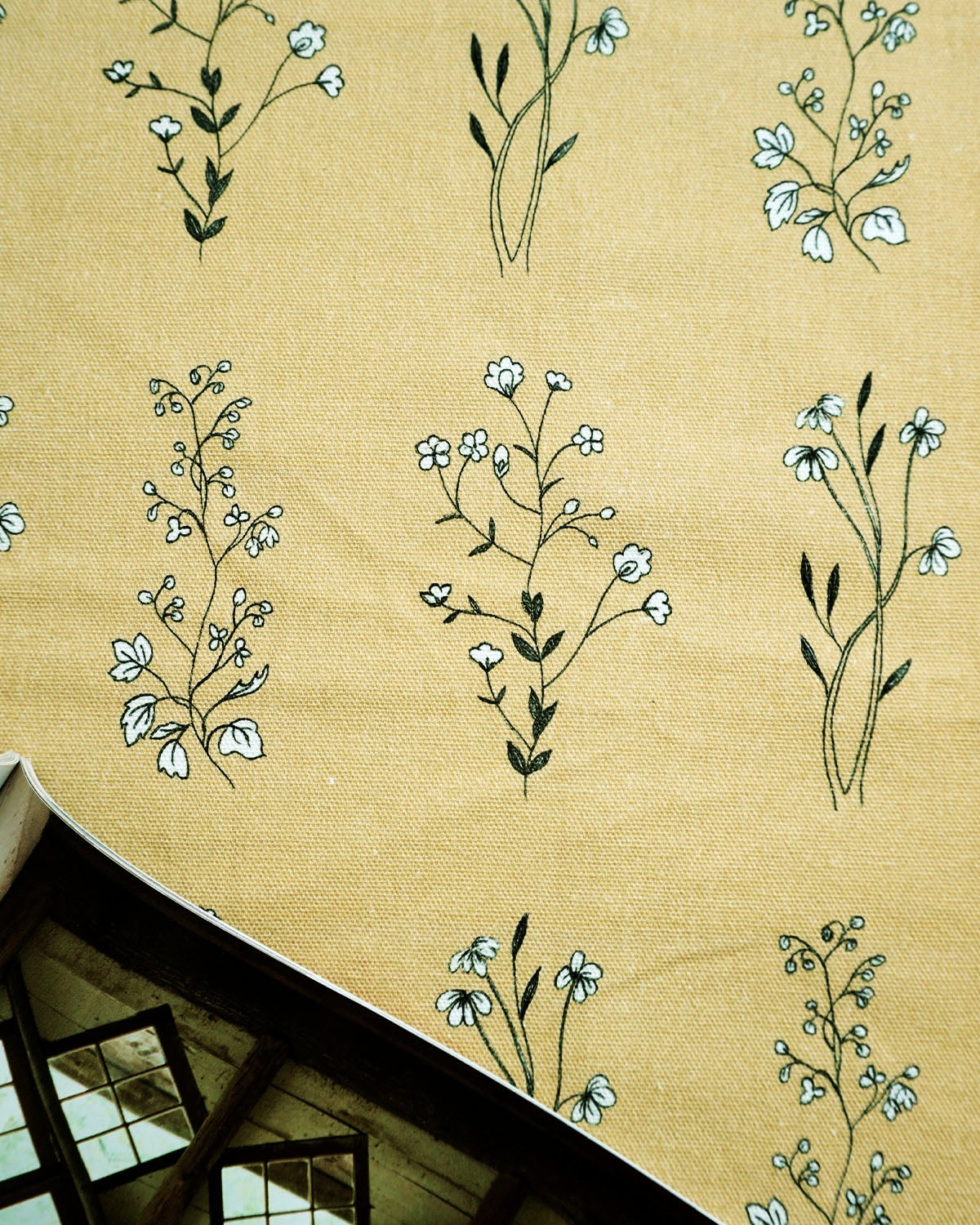 English Meadow print fabric in ochre with hand-drawn wildflowers; soft, nature-inspired pattern. 
